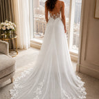 Back view of a lace bridal gown with flowing train